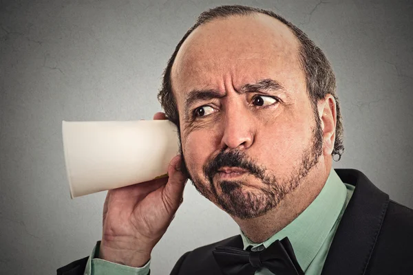 Curious businessman listening to conversation — Stock Photo, Image