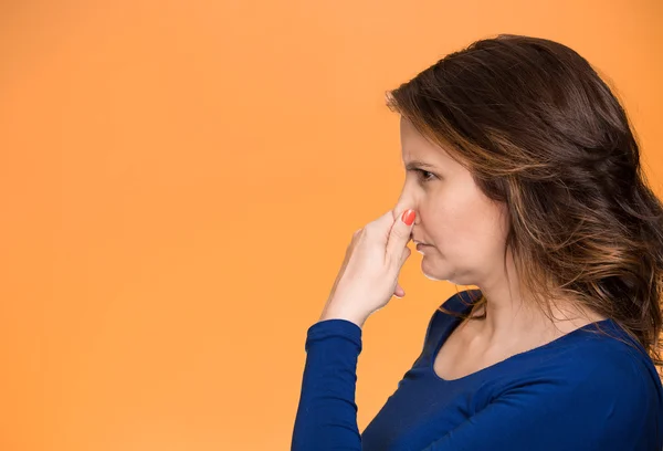 Bad smell woman covers pinches her nose — Stock Photo, Image