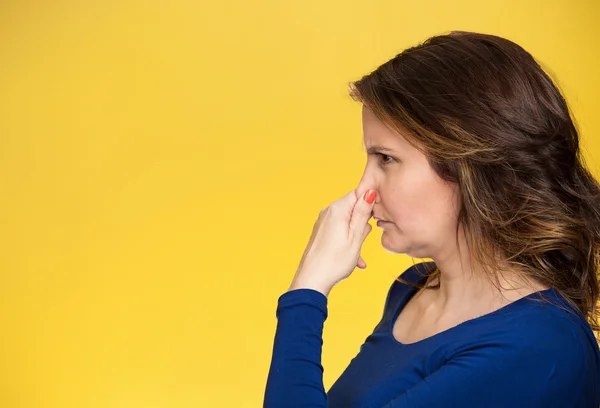 Mujer de mal olor cubre pellizca su nariz — Foto de Stock