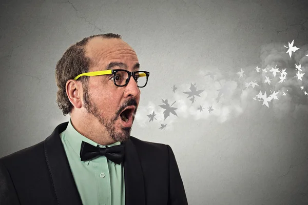 Headshot man with open mouth blowing cold breeze snowflakes flying away — Stock Photo, Image