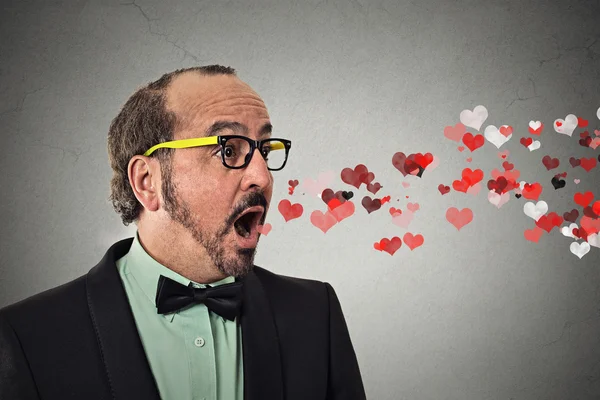 Man sending kisses, red hearts coming flying out of open mouth — Stock Photo, Image