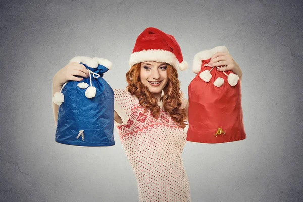 Christmas woman in santa claus red hat holding gift bags — Stock Photo, Image