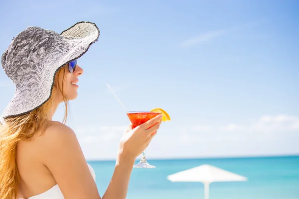 Donna in costume da bagno bianco con cocktail sulla spiaggia godendo di tempo soleggiato — Foto Stock