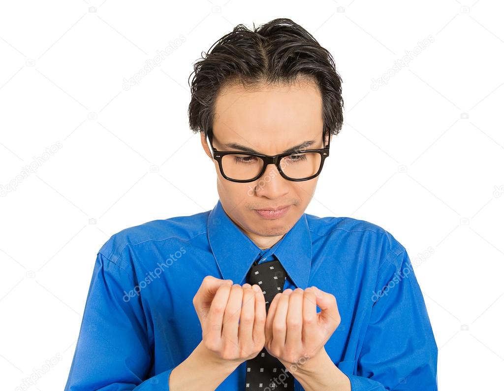 crazy perfectionist man with black glasses anxiously looking at fingernails