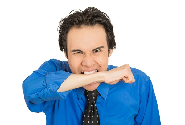 Crazy looking young mad man going nuts biting wrist arm — Stock Photo, Image