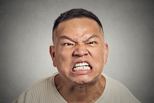 headshot angry middle aged man with open mouth aggressive screaming