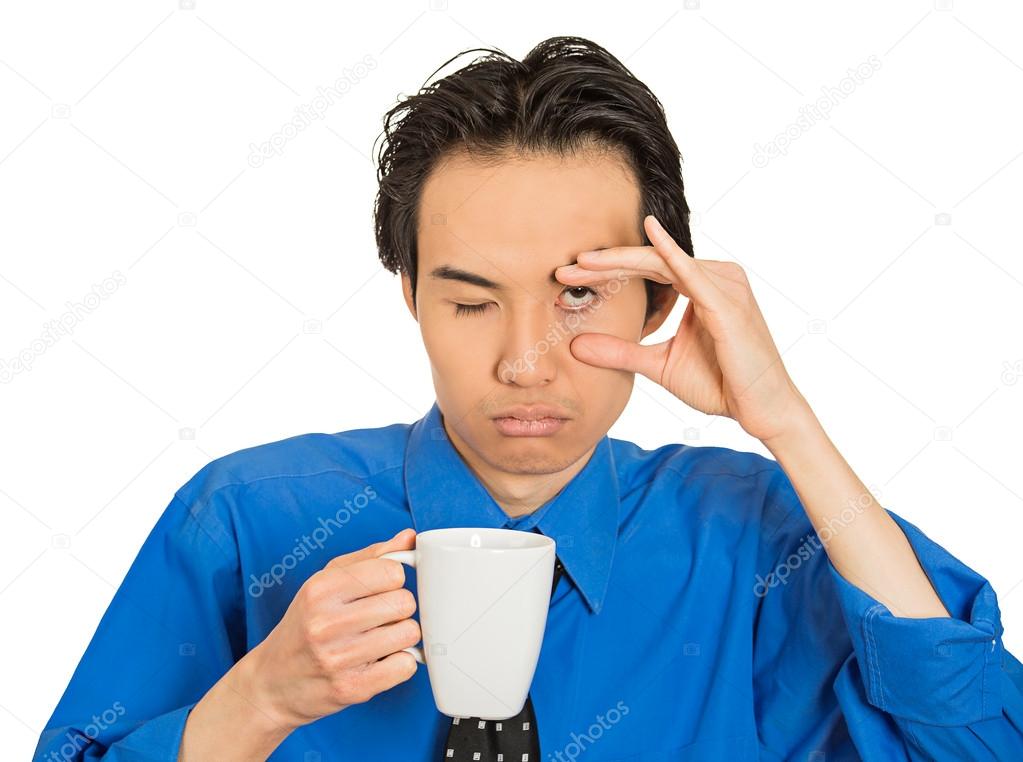 tired falling asleep young businessman holding cup of coffee
