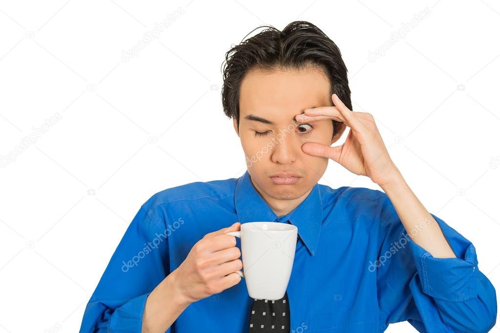 tired falling asleep young businessman holding cup of coffee