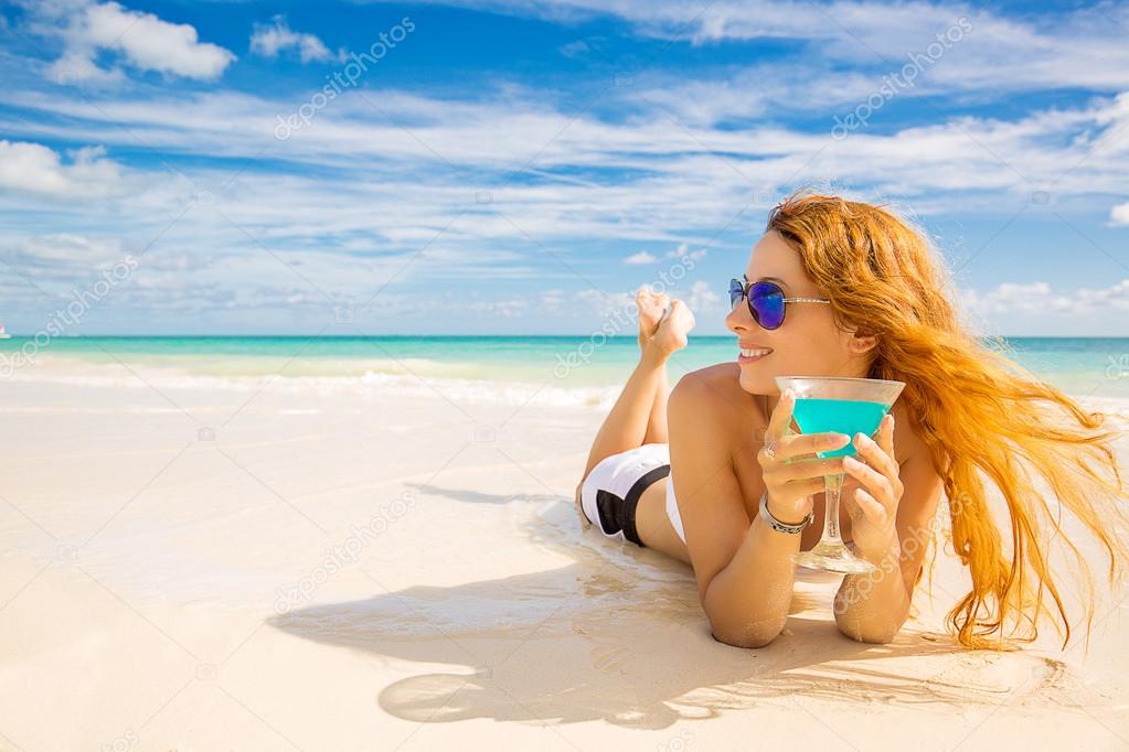 happy woman on the beach enjoying sunny weather