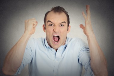 headshot angry upset young man fist in air open mouth yelling clipart