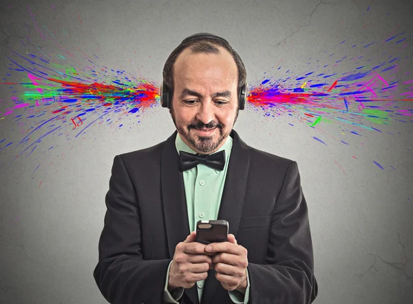 Man listening music with headphones sound colorful splashes — Stock Photo, Image
