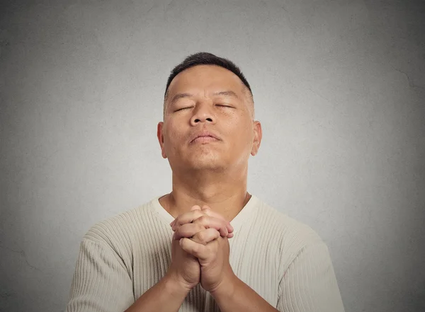 Middle aged man eyes closed praying looking up — Stock Photo, Image