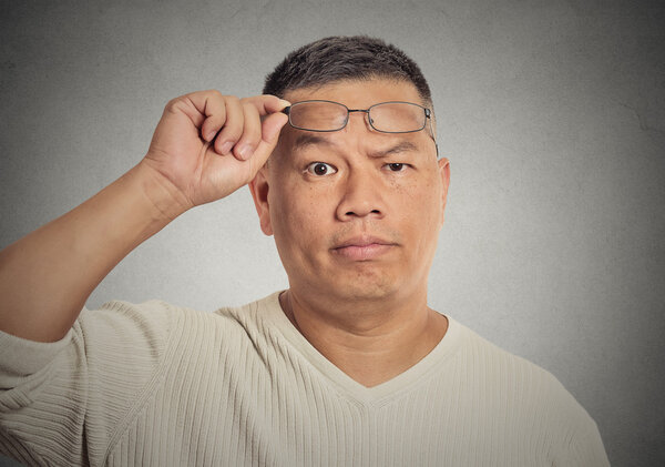 middle aged man with glasses skeptically looking at you