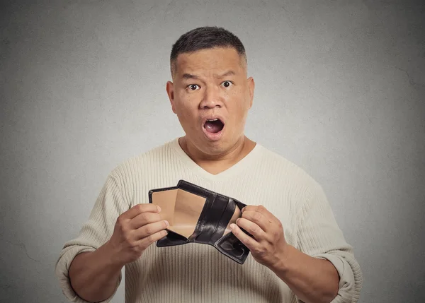 Shocked puzzled business man worker employee holding empty wallet — Stock Photo, Image