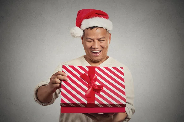 Excited surprised middle aged man opening unwrapping red gift box — Stock Photo, Image