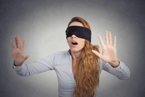 Young businesswoman walking blindfolded with hands forward — Stock Photo, Image