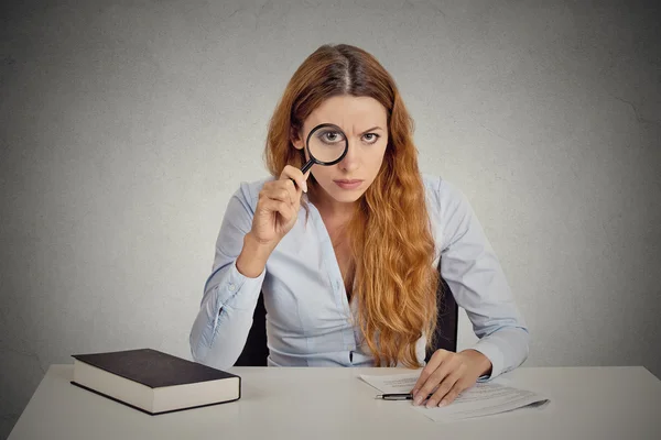 Woman with glasses skeptically looking at you through magnifying glass — Stock Photo, Image