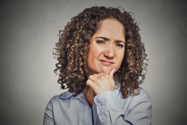 Skeptic. Doubtful woman looking at you 