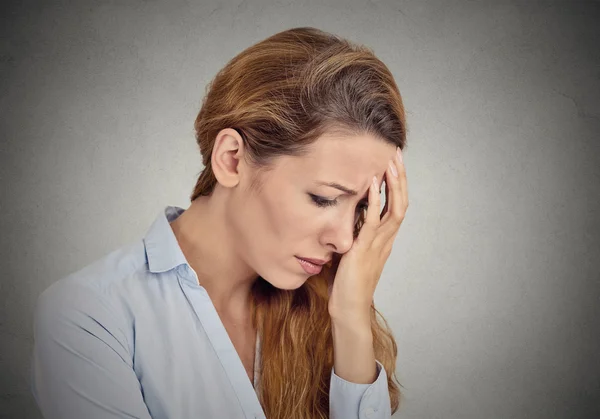 Portrait of sad young woman isolated on grey wall background — Stock Photo, Image