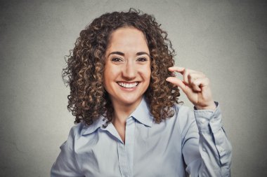 funny young woman showing small amount size gesture with hand clipart