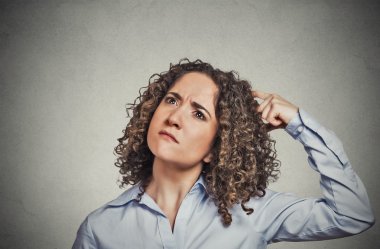 woman scratching head thinking daydreaming about something wondering  clipart