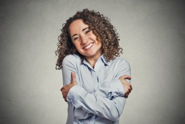 smiling woman holding hugging herself clipart