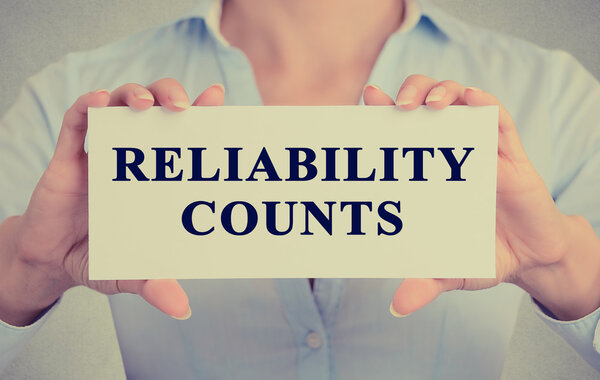 businesswoman hands holding white sign with message Reliability Counts