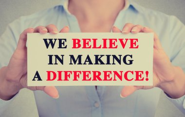 Businesswoman hands sign with We Believe in Making a Difference message clipart