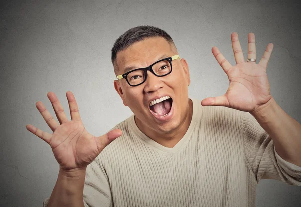 Super excited funky guy with glasses looking at you arms raised at camera — Stock Photo, Image