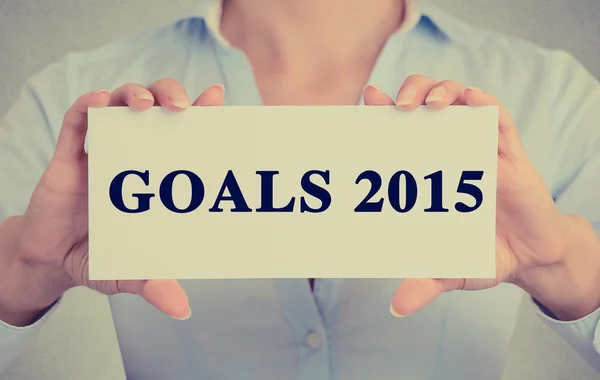 businesswoman hands holding sign with goals 2015 text message