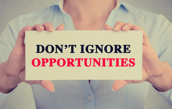 Businesswoman hands holding sign with don't ignore opportunities — Stock Photo, Image