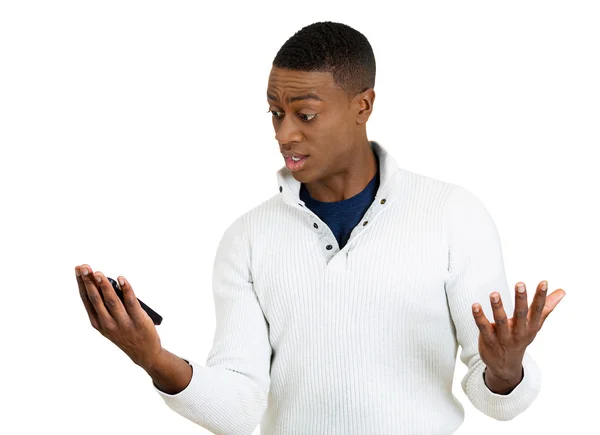 Junger Mann schockiert von dem, was er auf seinem Handy sieht — Stockfoto