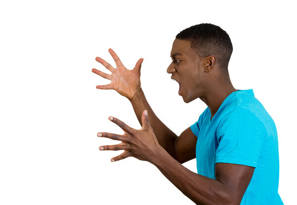  angry upset young man, employee, fists in air, open mouth yelling