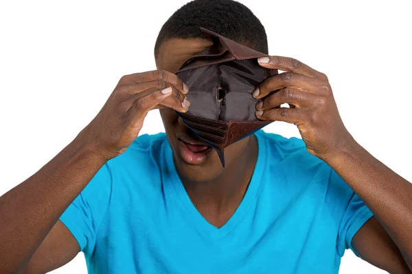 Broke young man showing empty wallet — Stock Photo, Image