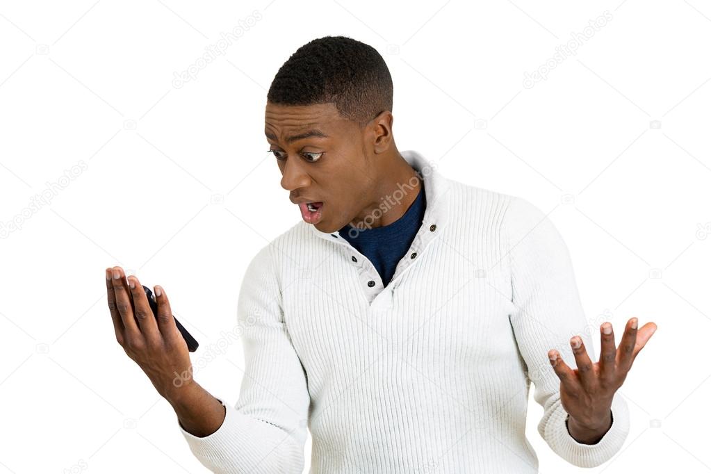 young man, shocked surprised by what he sees on his cell phone