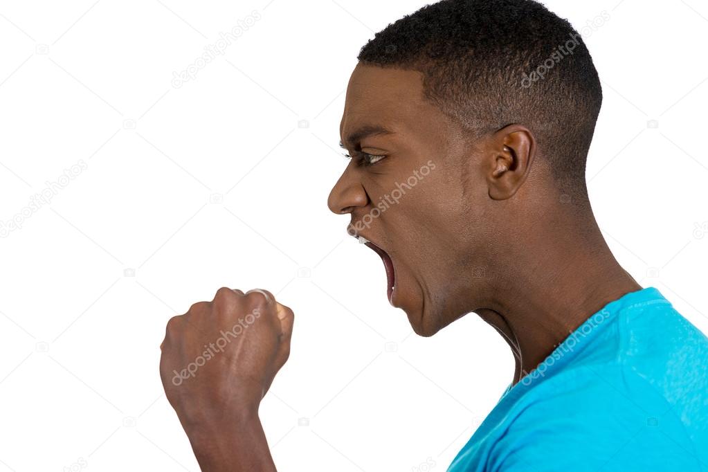  angry upset young man, employee, fists in air, open mouth yelling