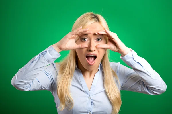 Surprised woman peeking looking through binoculars — Stock Photo, Image