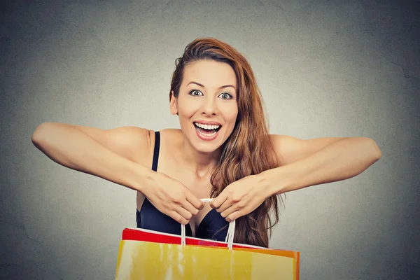 Woman with many shopping bags on gray background Royalty Free Stock Images