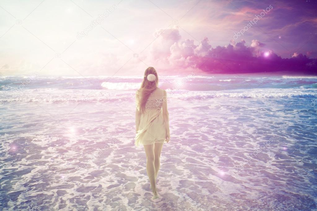 woman walking on dreamy beach enjoying ocean view