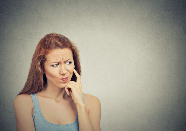 thoughtful skeptical suspicious young woman 