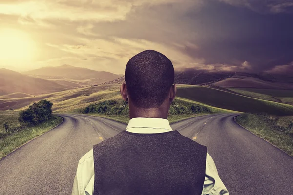 Businessman in front of two roads hoping taking chance — Stock Photo, Image