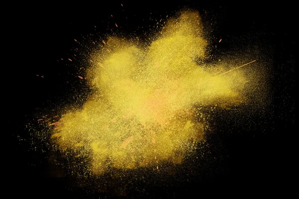 Freeze motion of colorful yellow powder exploding — Stock Photo, Image