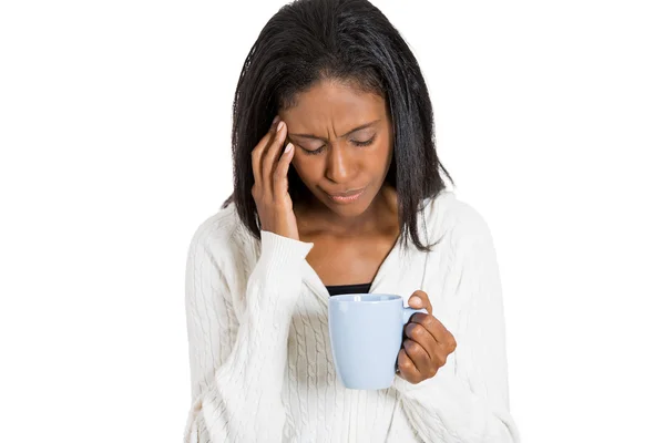 Tired sad woman looking at cup of coffee isolated — Stock Photo, Image