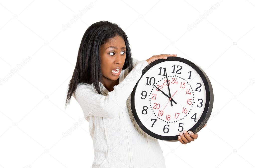 woman with clock anxious, pressured by lack of time 
