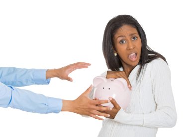woman holding piggy bank, frustrated trying to protect her savings