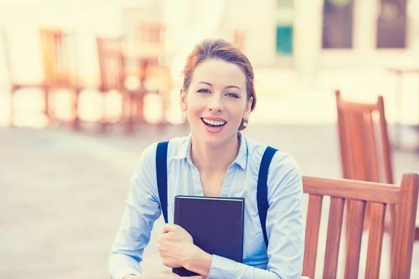 Laughing young woman with book — Stock Photo, Image