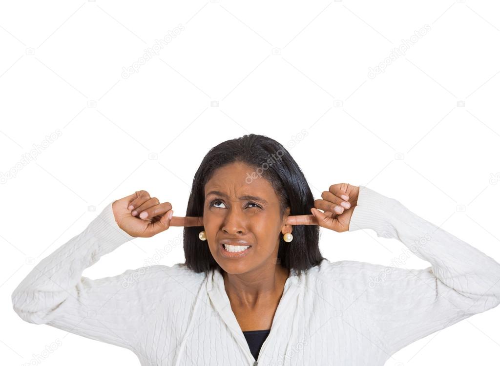stressed woman covering her ears looking up stop making loud noise
