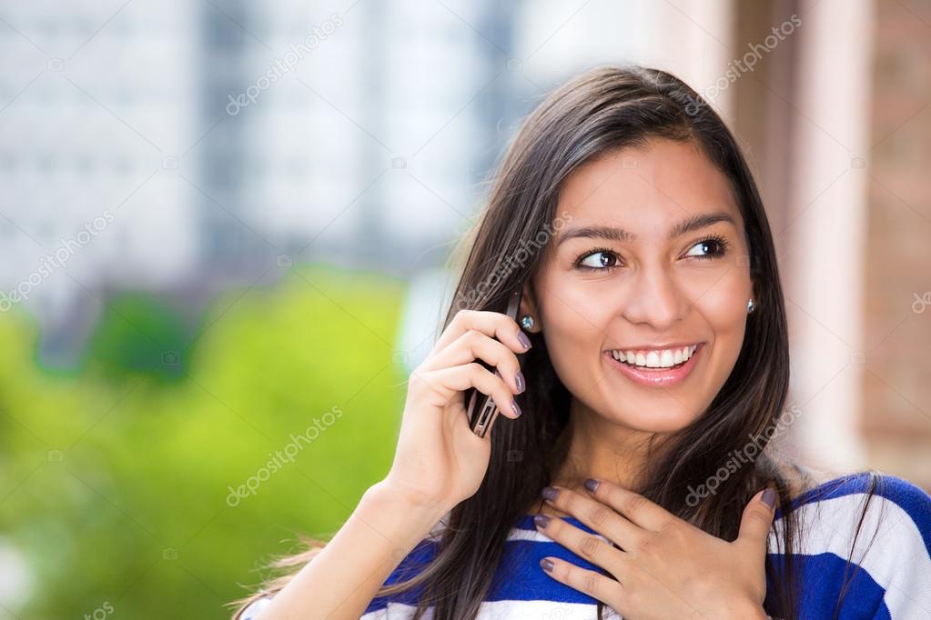 Happy woman talking on mobile phone outdoors city urban background 