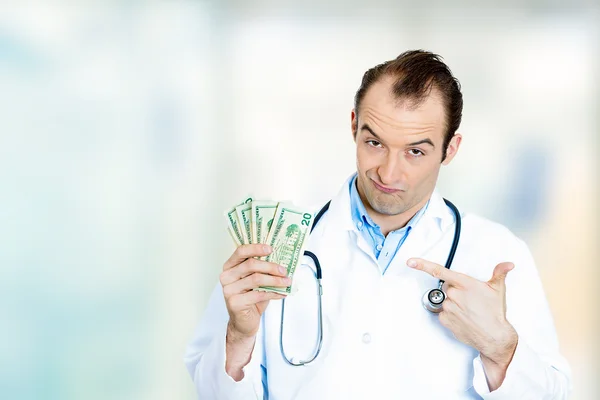 Greedy health care professional male doctor holding money dollar bills — Stock Photo, Image