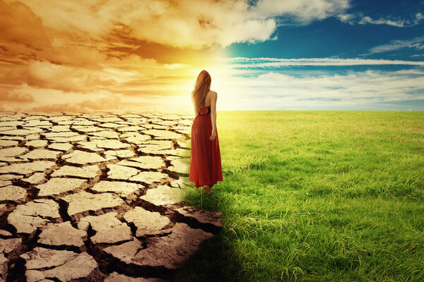 Climate Change Concept Woman walking through opened field 